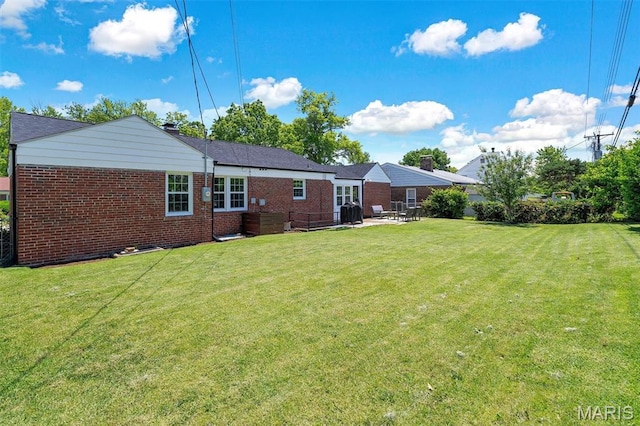 927 Gay Ave, Saint Louis, MO 63130 - rear view of property with brick siding, a yard, and a chimney