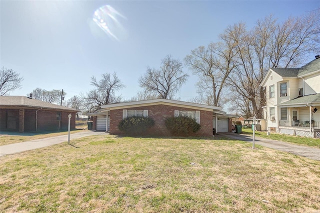 view of front facade with driveway, brick siding, an attached garage, and a front lawn