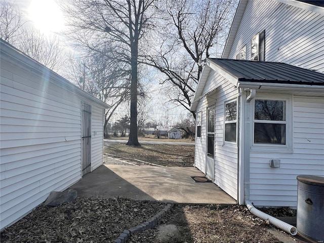 601 S Elm St, Center, MO 63436 - view of side of property with a patio area and metal roof