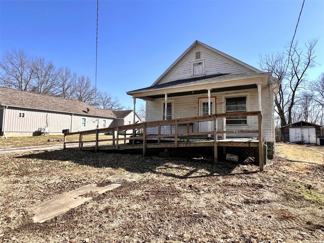 1046 E Water St, Hillsboro, IL 62049 - back of property with a storage unit, an outbuilding, and a porch