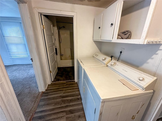 clothes washing area featuring washer and dryer, cabinet space, and dark wood-style flooring