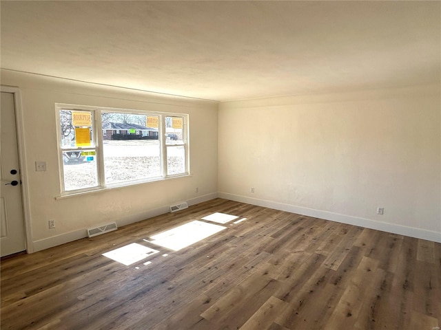 unfurnished room with wood finished floors and baseboards