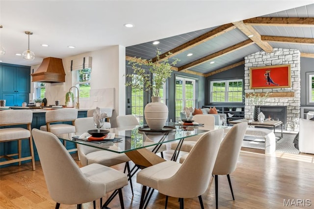 502 Briar Ridge Ln, Saint Louis, MO 63131 - dining room featuring light wood finished floors, plenty of natural light, a stone fireplace, recessed lighting, and wood ceiling