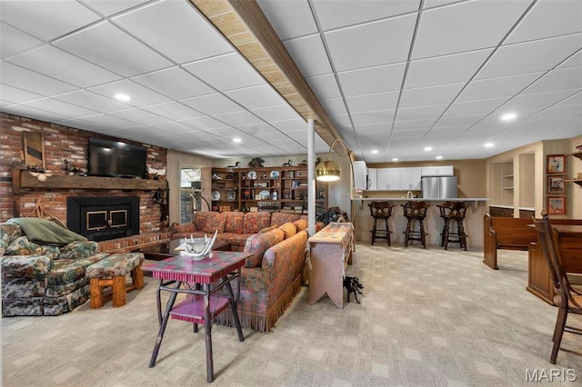 167 Red Fox Ln, Cape Girardeau, MO 63701 - living area featuring light carpet, a fireplace, a drop ceiling, and recessed lighting