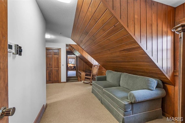 167 Red Fox Ln, Cape Girardeau, MO 63701 - living area with wood walls, carpet flooring, vaulted ceiling, and baseboards