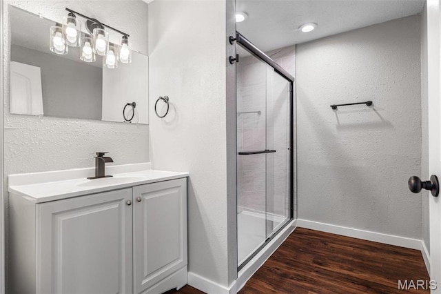 1005 Tyler St, Park Hills, MO 63601 - bathroom featuring wood finished floors, baseboards, a stall shower, vanity, and a textured wall