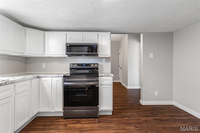 1005 Tyler St, Park Hills, MO 63601 - kitchen featuring stainless steel appliances, dark wood-type flooring, white cabinetry, baseboards, and a textured ceiling
