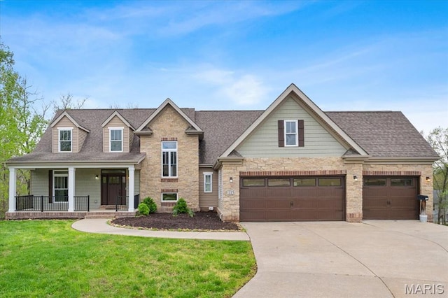 115 Place De Yeager, Lake St Louis, MO 63367 - view of front of property featuring driveway, covered porch, stone siding, a front lawn, and roof with shingles