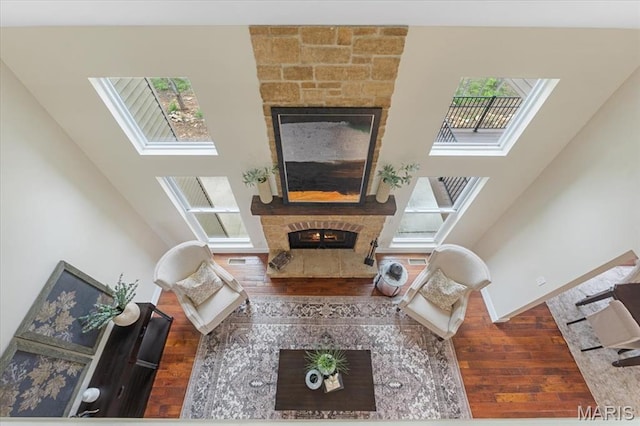 115 Place De Yeager, Lake St Louis, MO 63367 - living room with a fireplace, wood finished floors, a skylight, and baseboards