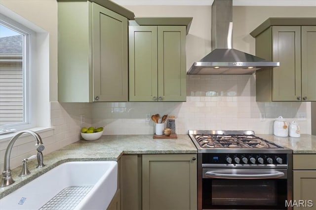 115 Place De Yeager, Lake St Louis, MO 63367 - kitchen with gas range, wall chimney exhaust hood, a sink, decorative backsplash, and green cabinetry