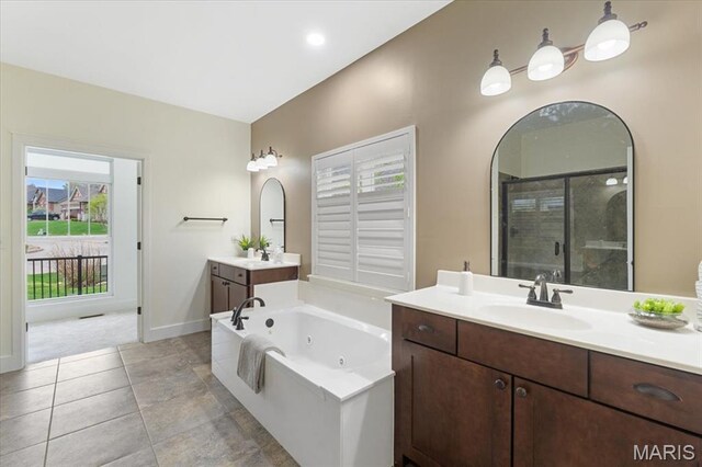 115 Place De Yeager, Lake St Louis, MO 63367 - bathroom featuring a shower stall, a jetted tub, baseboards, and two vanities