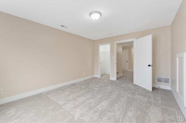 115 Place De Yeager, Lake St Louis, MO 63367 - unfurnished bedroom with light carpet, baseboards, a walk in closet, and a closet