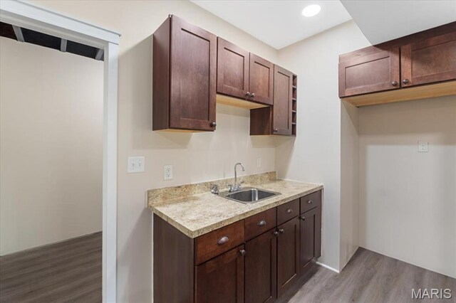 115 Place De Yeager, Lake St Louis, MO 63367 - kitchen with a sink, light wood finished floors, light countertops, and dark brown cabinetry