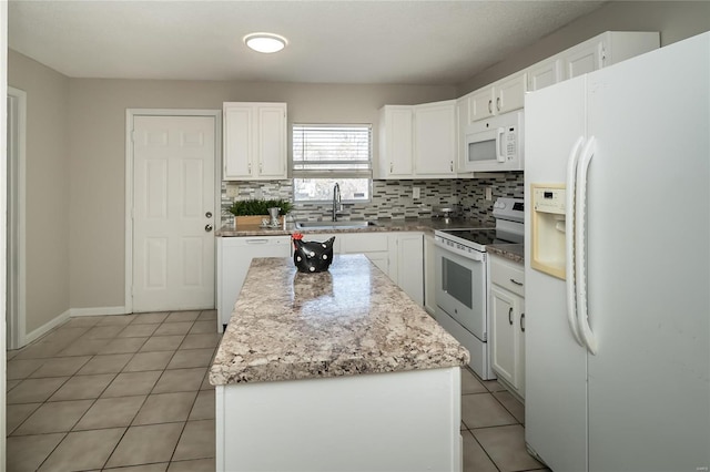 133 Lithia Ave, Saint Louis, MO 63119 - kitchen with white appliances, a sink, tasteful backsplash, light tile patterned floors, and a kitchen island