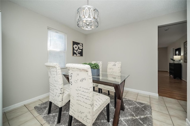 133 Lithia Ave, Saint Louis, MO 63119 - dining room featuring light tile patterned floors, a chandelier, and baseboards
