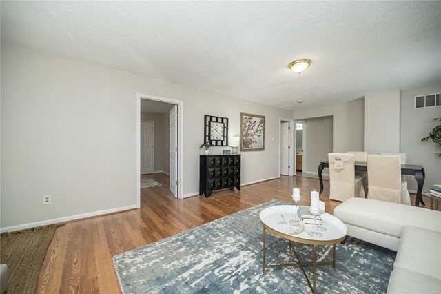 133 Lithia Ave, Saint Louis, MO 63119 - living room with wood finished floors, baseboards, and a textured ceiling