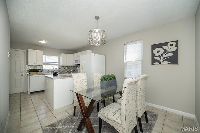 133 Lithia Ave, Saint Louis, MO 63119 - dining room with light tile patterned floors, a chandelier, and baseboards