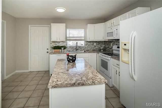 133 Lithia Ave, Saint Louis, MO 63119 - kitchen with white appliances, a sink, backsplash, a center island, and light tile patterned floors