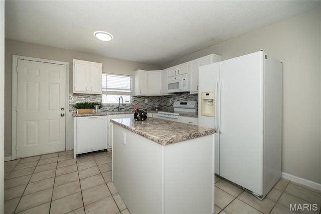 133 Lithia Ave, Saint Louis, MO 63119 - kitchen featuring white appliances, tasteful backsplash, white cabinetry, a sink, and a kitchen island