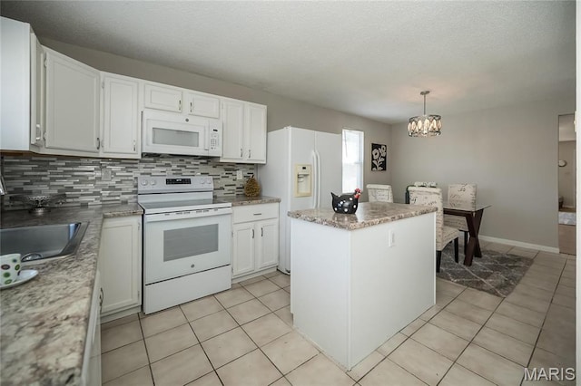 133 Lithia Ave, Saint Louis, MO 63119 - kitchen featuring white appliances, tasteful backsplash, a chandelier, a kitchen island, and light tile patterned floors
