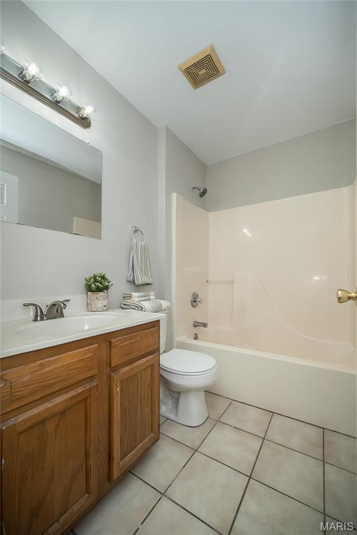 133 Lithia Ave, Saint Louis, MO 63119 - bathroom with tile patterned floors, vanity, toilet, and shower / bathtub combination