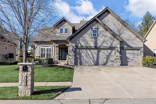 traditional home featuring driveway, a front yard, stone siding, and a garage