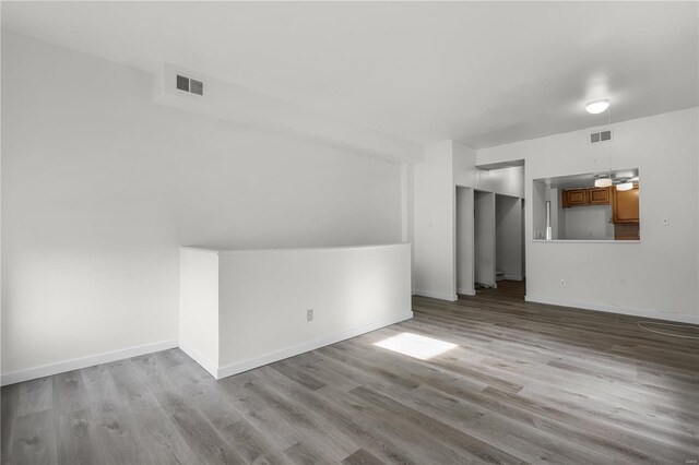4515 Margaretta Ave, Saint Louis, MO 63115 - unfurnished living room featuring wood finished floors and baseboards