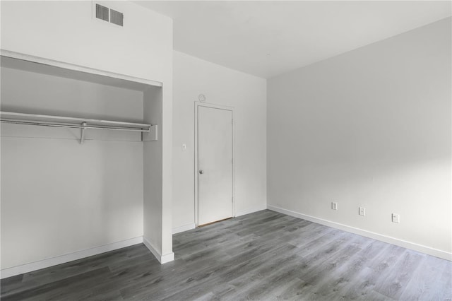 4515 Margaretta Ave, Saint Louis, MO 63115 - unfurnished bedroom with wood finished floors, a closet, and baseboards