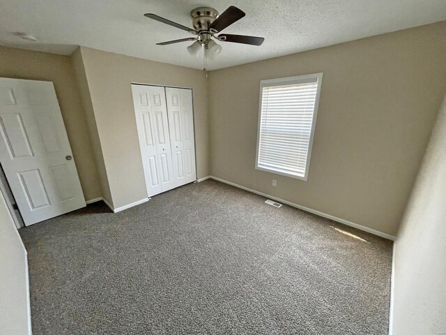 12 Lynnwood Ct, Belleville, IL 62226 - unfurnished bedroom with baseboards, dark colored carpet, a closet, and ceiling fan