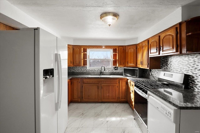 kitchen with white appliances, open shelves, a sink, light marble finish flooring, and brown cabinets