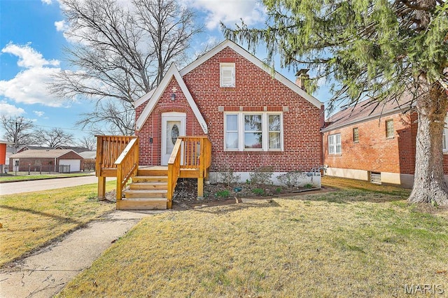 5800 Marquette Ave, Saint Louis, MO 63139 - tudor home featuring a front lawn, brick siding, and a chimney