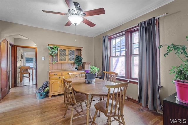 5800 Marquette Ave, Saint Louis, MO 63139 - dining area with arched walkways, light wood finished floors, and ceiling fan