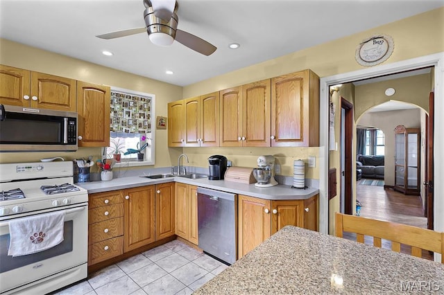 5800 Marquette Ave, Saint Louis, MO 63139 - kitchen with stainless steel appliances, a sink, arched walkways, ceiling fan, and recessed lighting