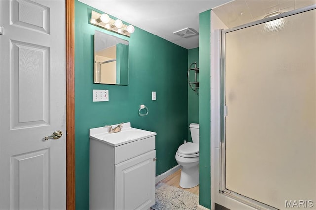 5800 Marquette Ave, Saint Louis, MO 63139 - full bathroom with wood finished floors, a stall shower, toilet, and vanity