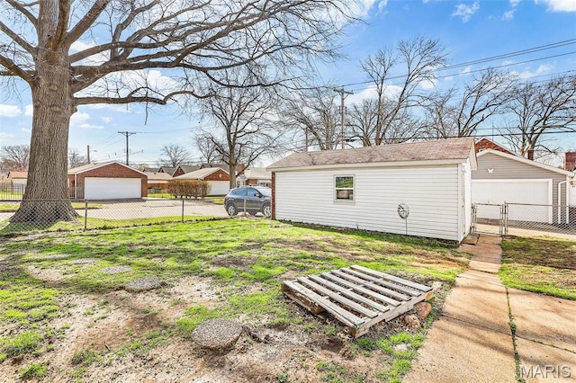5800 Marquette Ave, Saint Louis, MO 63139 - view of yard with a detached garage, fence, an outdoor structure, and a gate