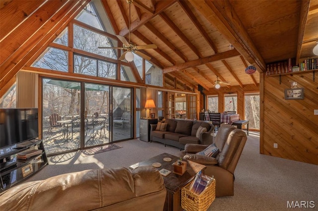 1703 Wynnbrook Woods Dr, Innsbrook, MO 63390 - carpeted living room featuring high vaulted ceiling, a ceiling fan, wooden walls, and wood ceiling with exposed beams