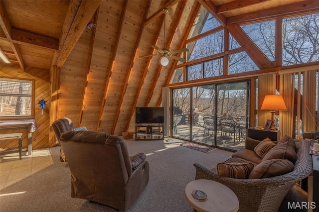 1703 Wynnbrook Woods Dr, Innsbrook, MO 63390 - living area with high vaulted ceiling, wood walls, carpet, wooden ceiling with exposed beams, and a ceiling fan