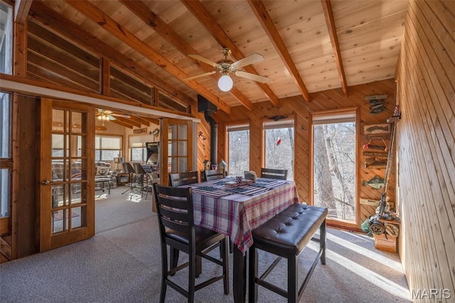 1703 Wynnbrook Woods Dr, Innsbrook, MO 63390 - carpeted dining room with french doors, a ceiling fan, wood walls, wood ceiling with exposed beams, and high vaulted ceiling