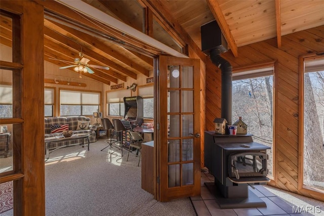 1703 Wynnbrook Woods Dr, Innsbrook, MO 63390 - office with a wood stove, wood walls, ceiling fan, wooden ceiling, and carpet flooring