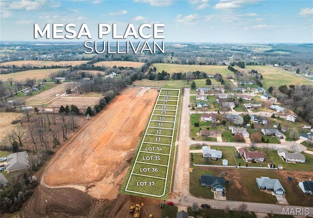 aerial view of property and surrounding area featuring property parcel outlined