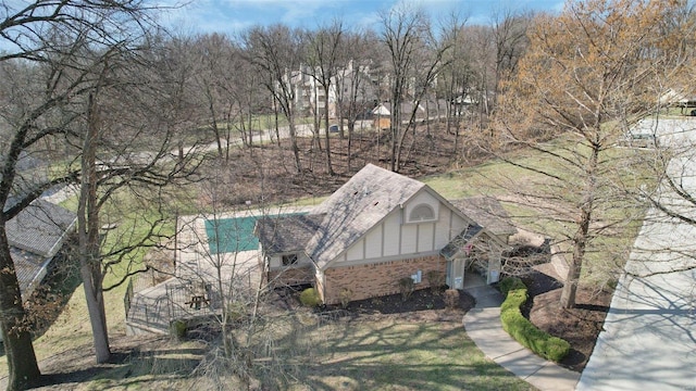 view of home's exterior featuring brick siding and roof with shingles