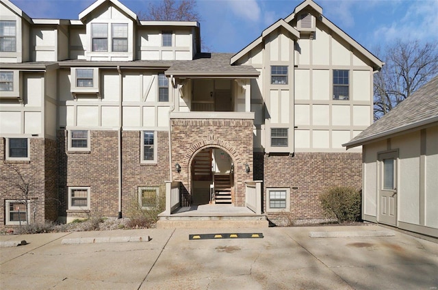 view of front of home with brick siding and stucco siding