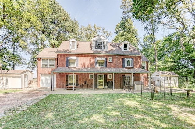 rear view of house featuring brick siding and driveway