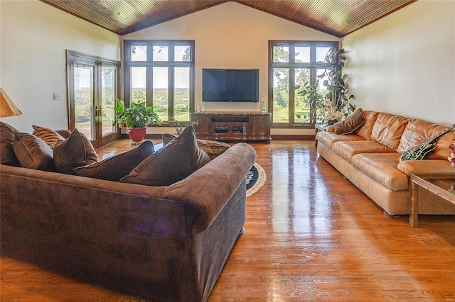 living area with high vaulted ceiling, wood finished floors, healthy amount of natural light, and wooden ceiling