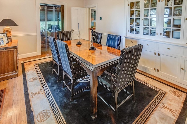 dining room with light wood finished floors and baseboards