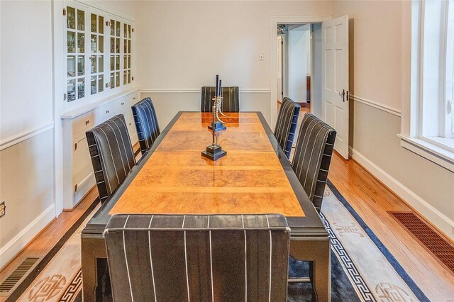 dining area with wood finished floors and baseboards