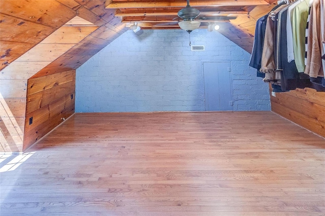 additional living space with wood finished floors, a ceiling fan, and lofted ceiling