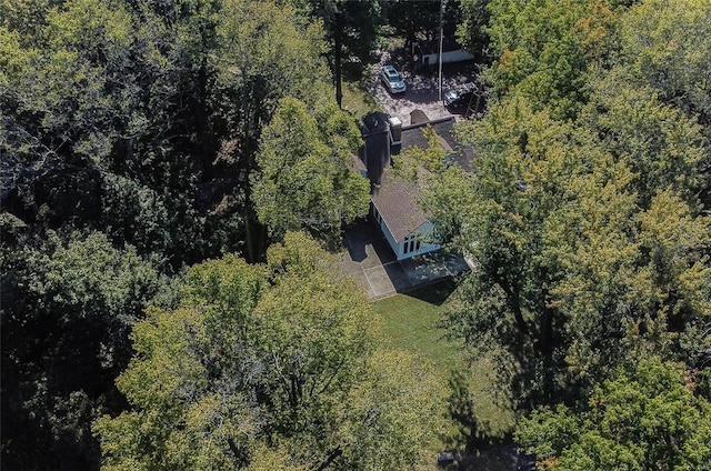 aerial view of property and surrounding area featuring a forest