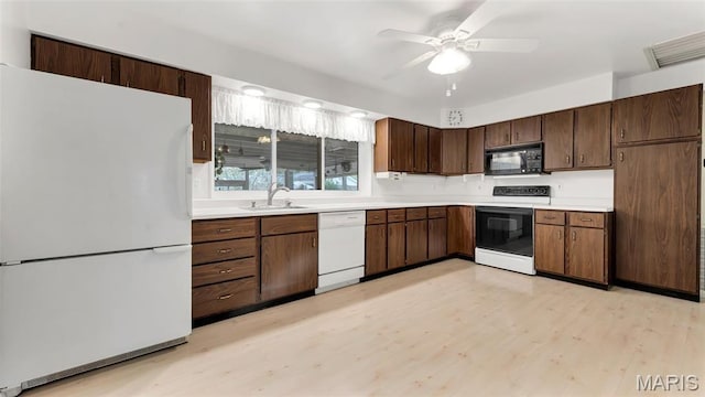 912 Salem Way, Ellisville, MO 63021 - kitchen with white appliances, a sink, light wood-style floors, and light countertops
