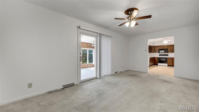 912 Salem Way, Ellisville, MO 63021 - unfurnished living room featuring a ceiling fan, light carpet, and baseboards